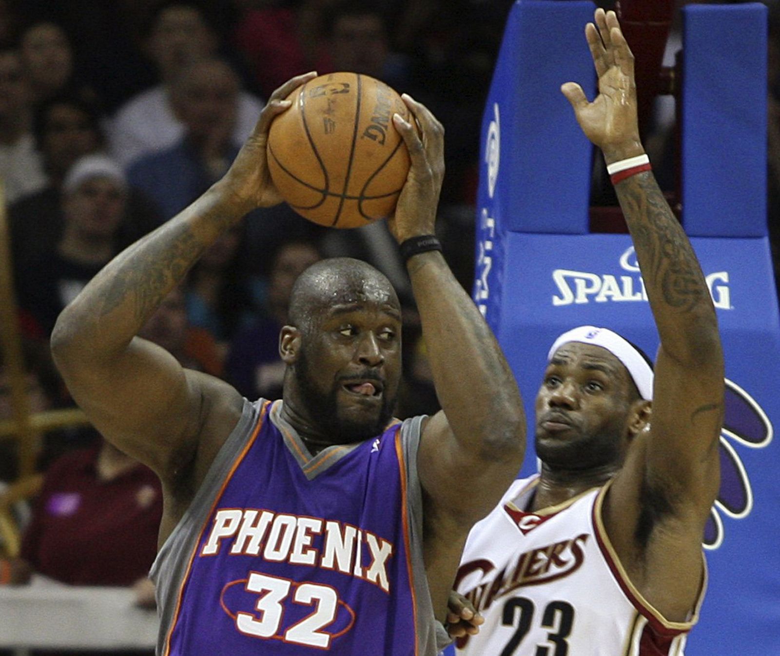 Phoenix Suns' O'Neal attempts to put up a shot while defended by Cleveland Cavaliers' James in Cleveland