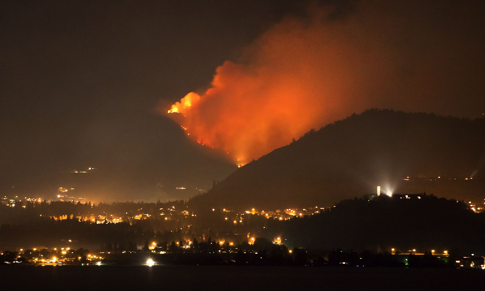 A forest fire burns on the edge of Kelowna, British Columbia, northeast of Vancouver