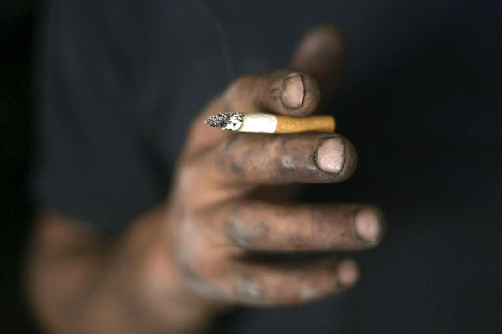 Palestinian mechanic smokes a cigarette in Ramallah