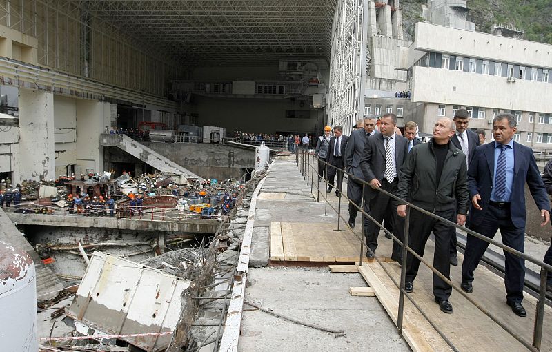 Russia's Prime Minister Vladimir Putin listens to Emergency Situation Minister Sergei Shoigu at the damaged Sayano-Shushenskaya hydroelectric power station near the Siberian village of Cheryomushki