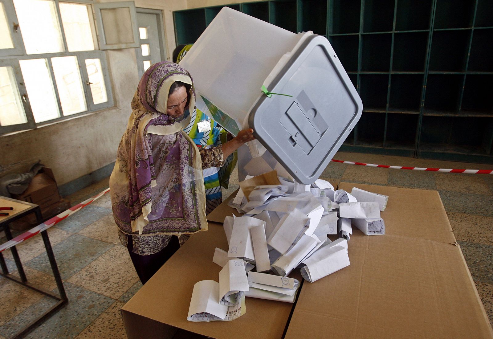 Una presidenta de mesa abre una urna para el recuento en Kandahar.
