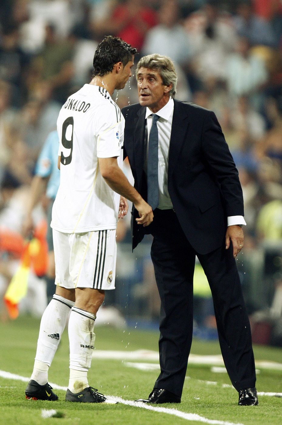 Real Madrid's Ronaldo listens to coach Pellegrini during Spanish first division against Deportivo Coruna  in Madrid