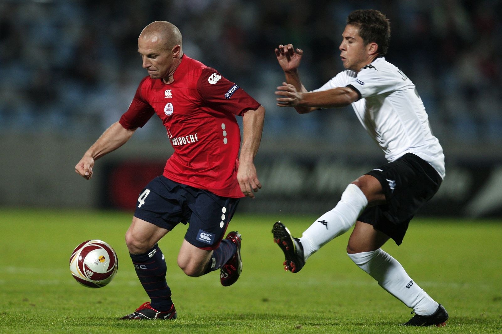 Lille's Vittek and Valencia's Alba fight for the ball during their UEFA Europa League Group B match in Villeneuve d'Ascq