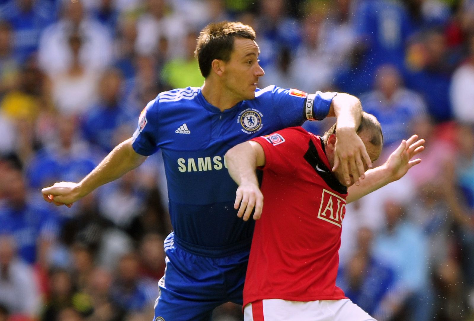 Chelsea's Terry challenges Manchester United's Rooney during their English Community Shield soccer match in London