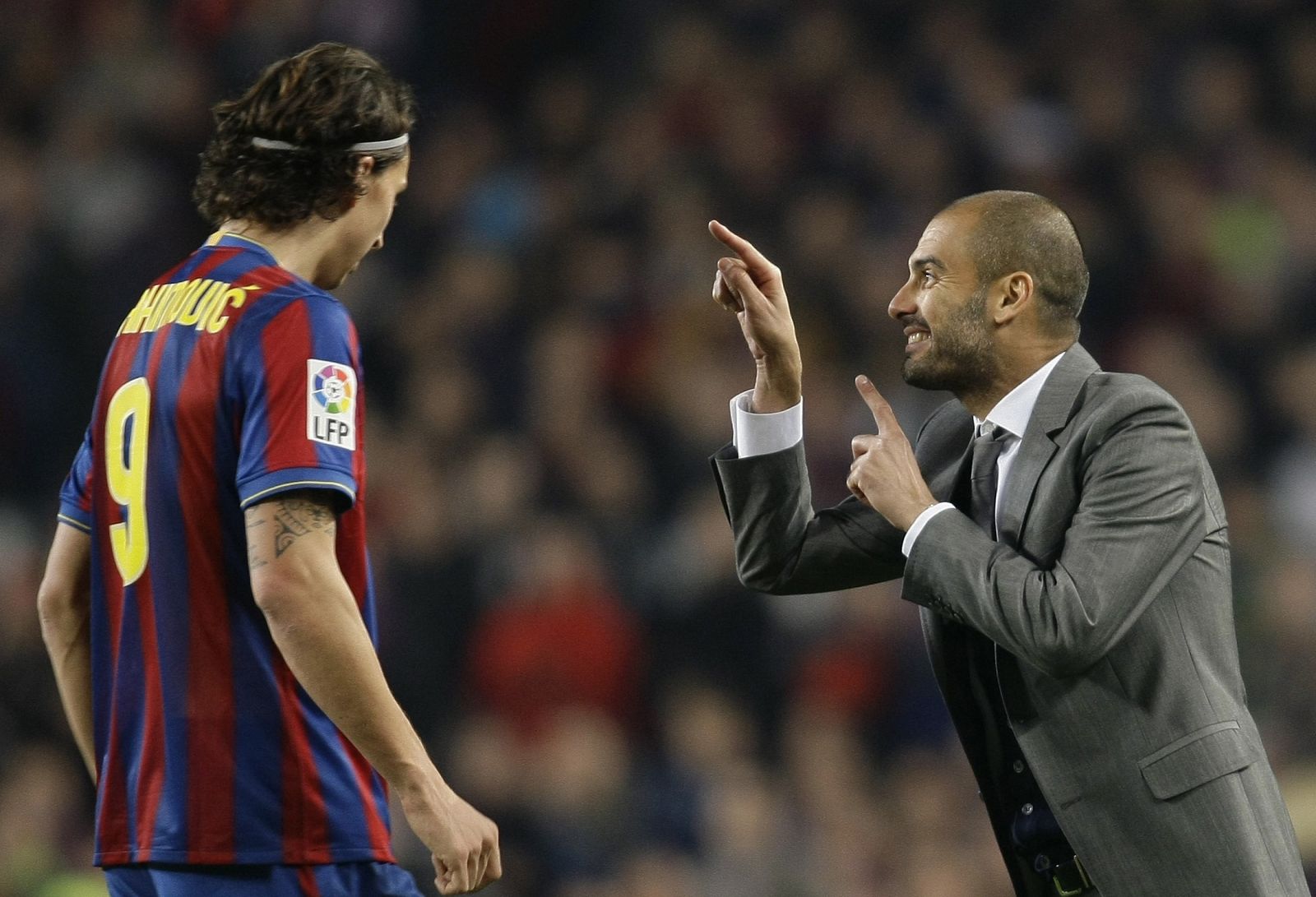 Barcelona's Ibrahimovic listens to coach Guardiola during their Spanish first division soccer match in Barcelona