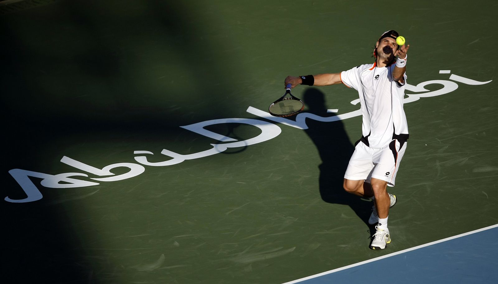 Spain's David Ferrer serves against Russia's Nikolay Davydenko at the Capitala World Tennis Championship in Abu Dhabi
