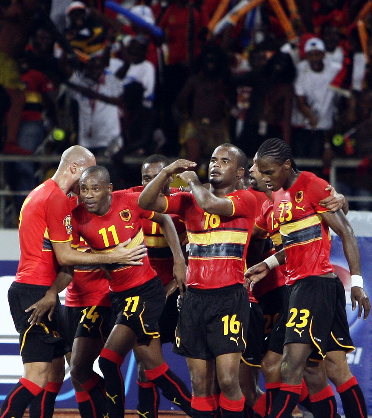 Flavio of Angola celebrates with his team after scoring against Mali during the opening match of the African Nations Cup soccer tournament in Luanda