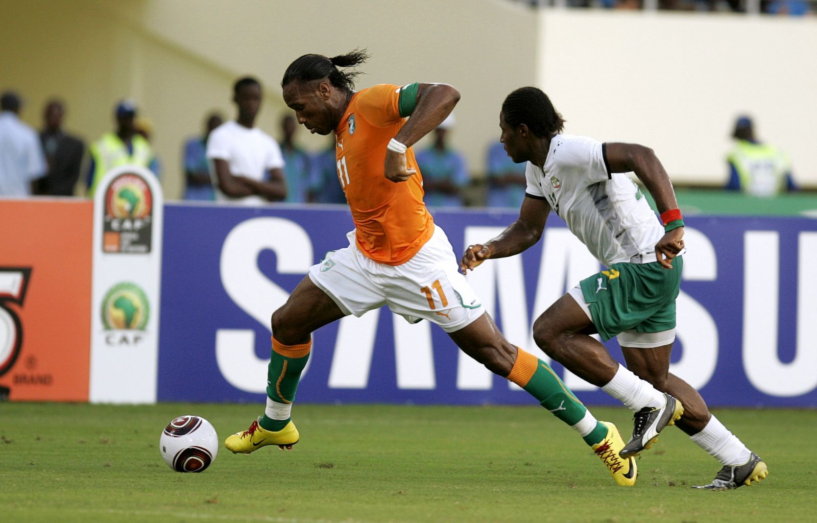 Drogba of Ivory Coast challenges Kere of Burkina Faso during their match at the African Nations Cup soccer tournament in Cabinda