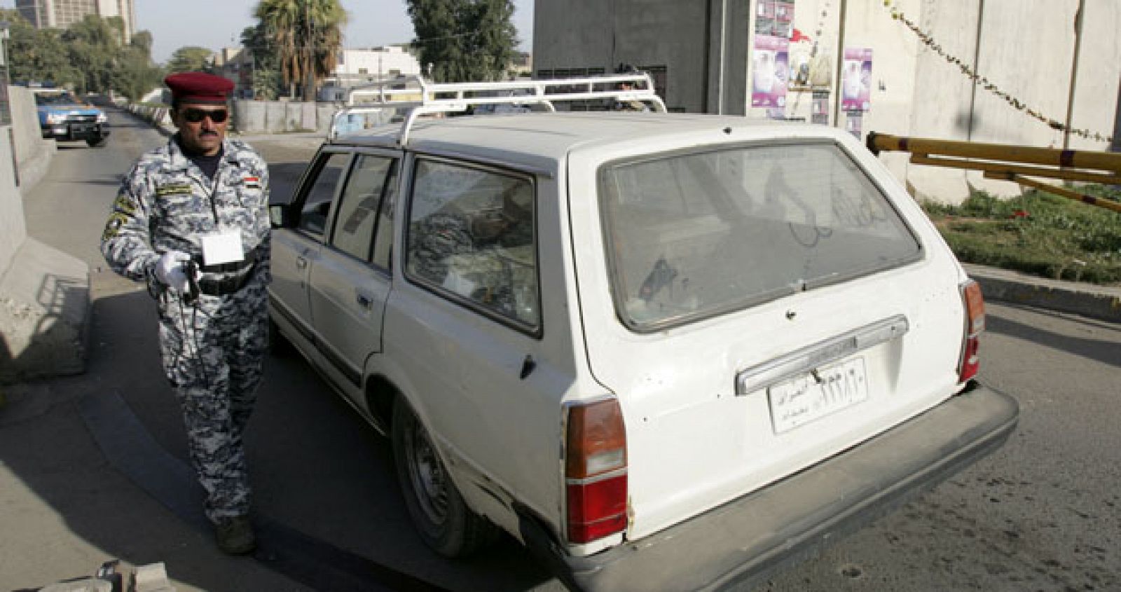 Un policía usa un escáner para inspeccionar un vehículo en Bagdad