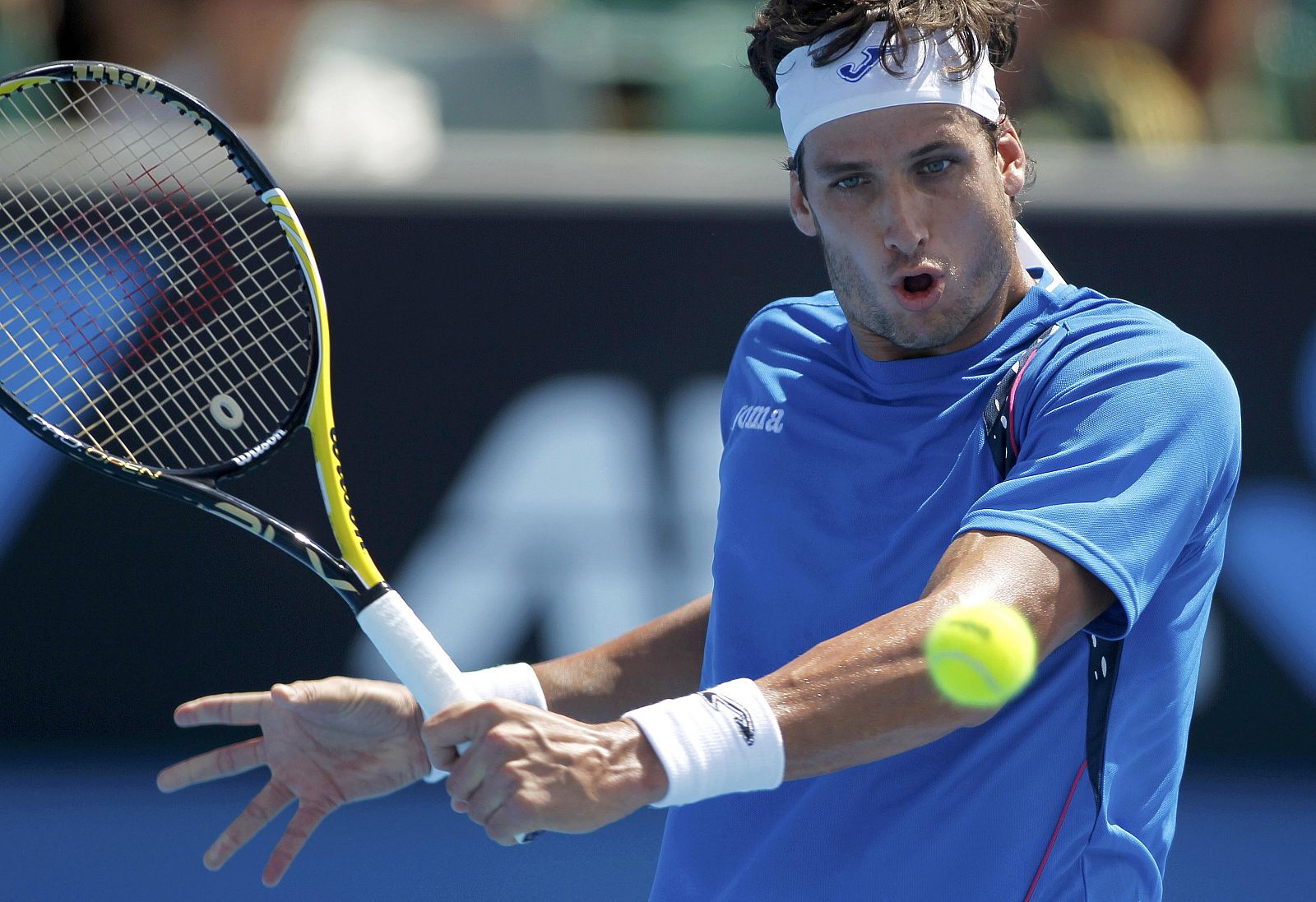 Lopez returns a shot against Schuettler at the Australian Open tennis tournament in Melbourne