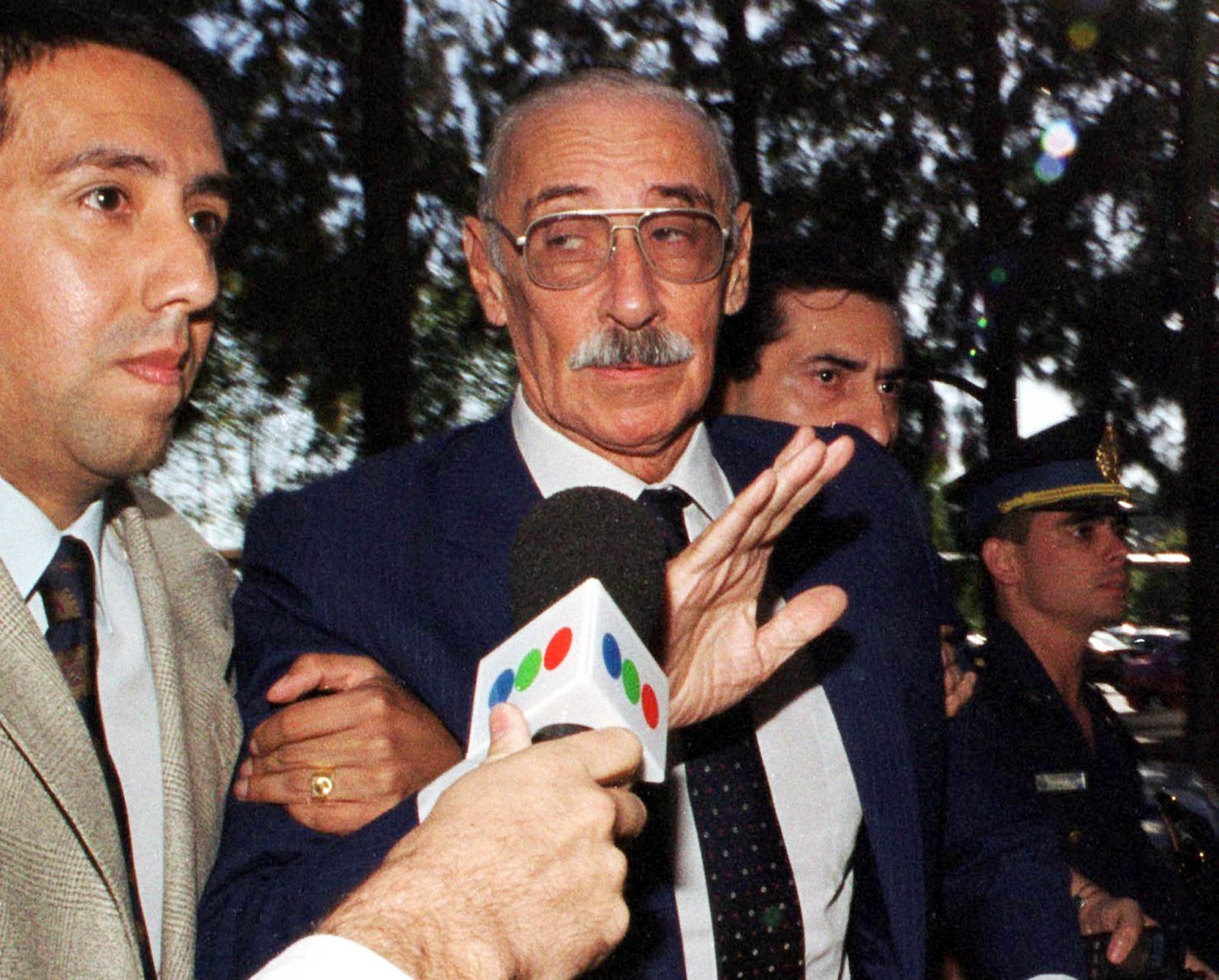 FORMER MILITARY DICTATOR VIDELA IS ESCORTED INTO THE COURTHOUSE.