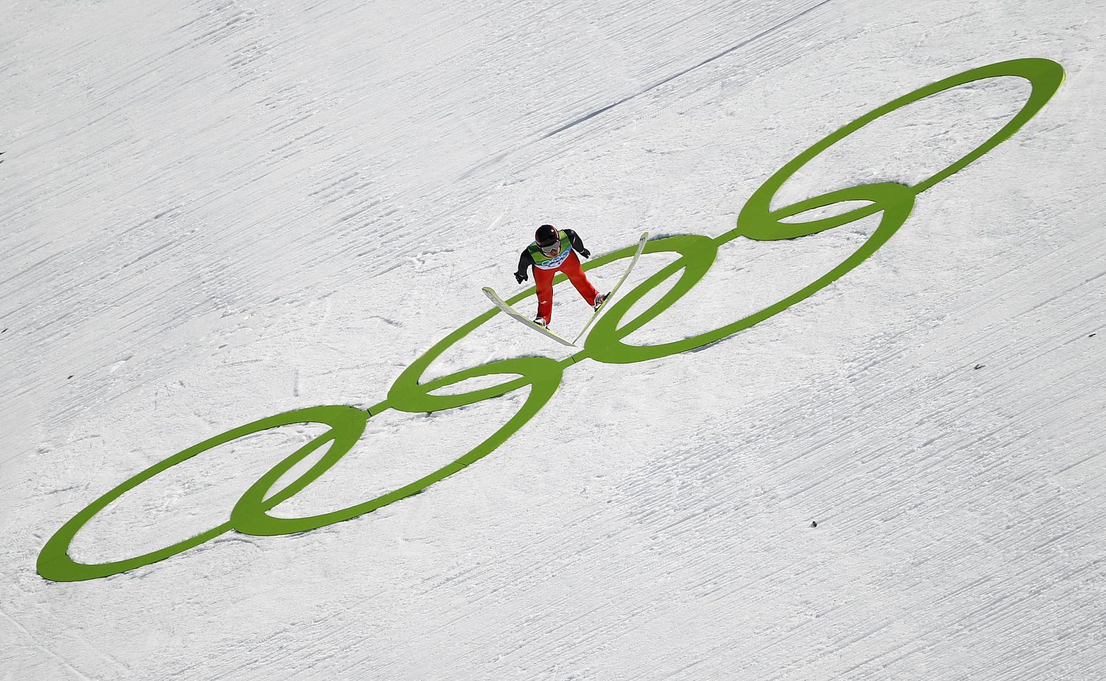 Ammann of Switzerland soars through the air during the first jump of the individual large hill ski jumping event at the Vancouver 2010 Winter Olympics in Whistler