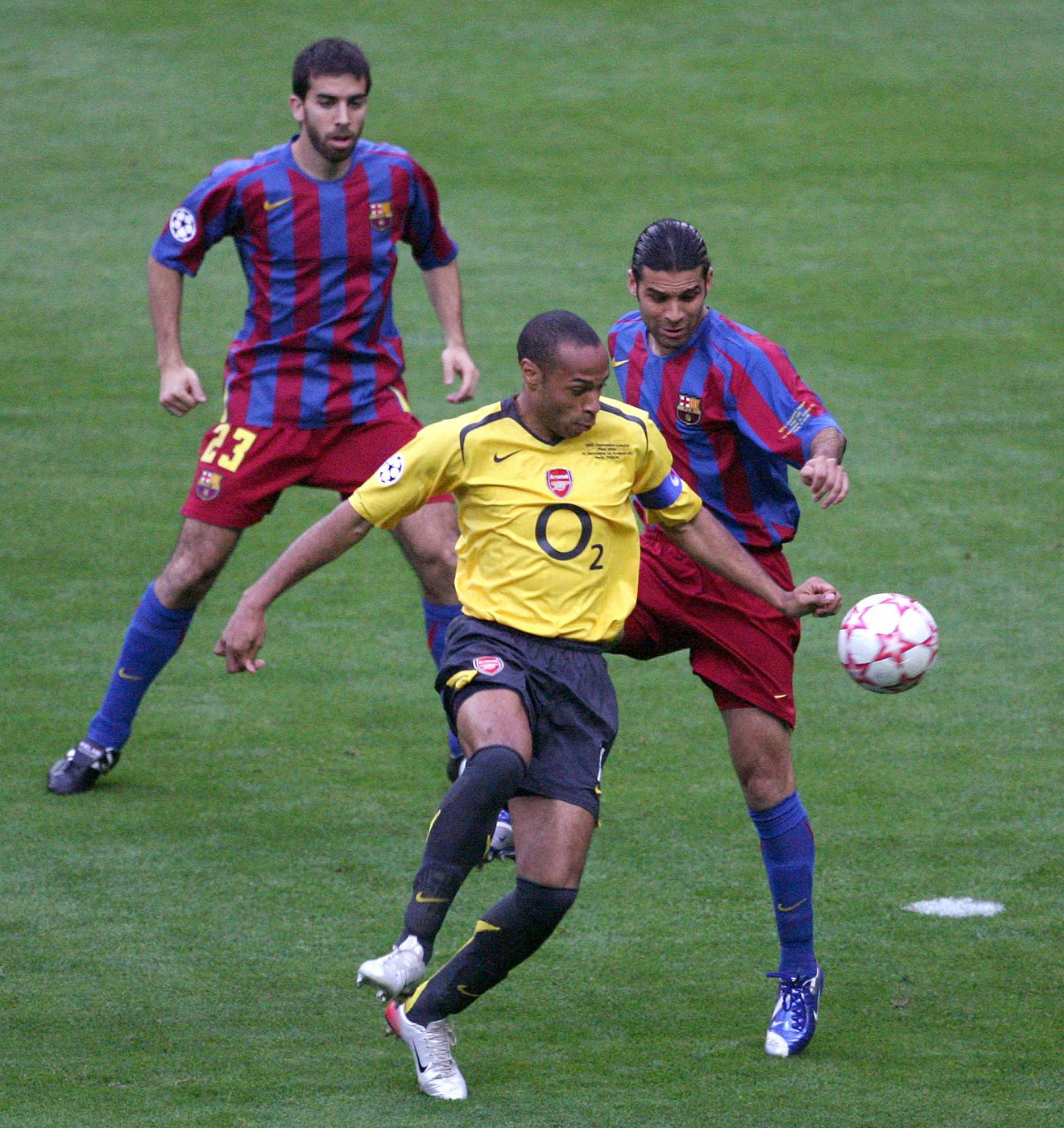 Barcelona's Marquez of Mexico attempts to tackle Arsenal's Henry of France during their Champions League final soccer match at Stade de France