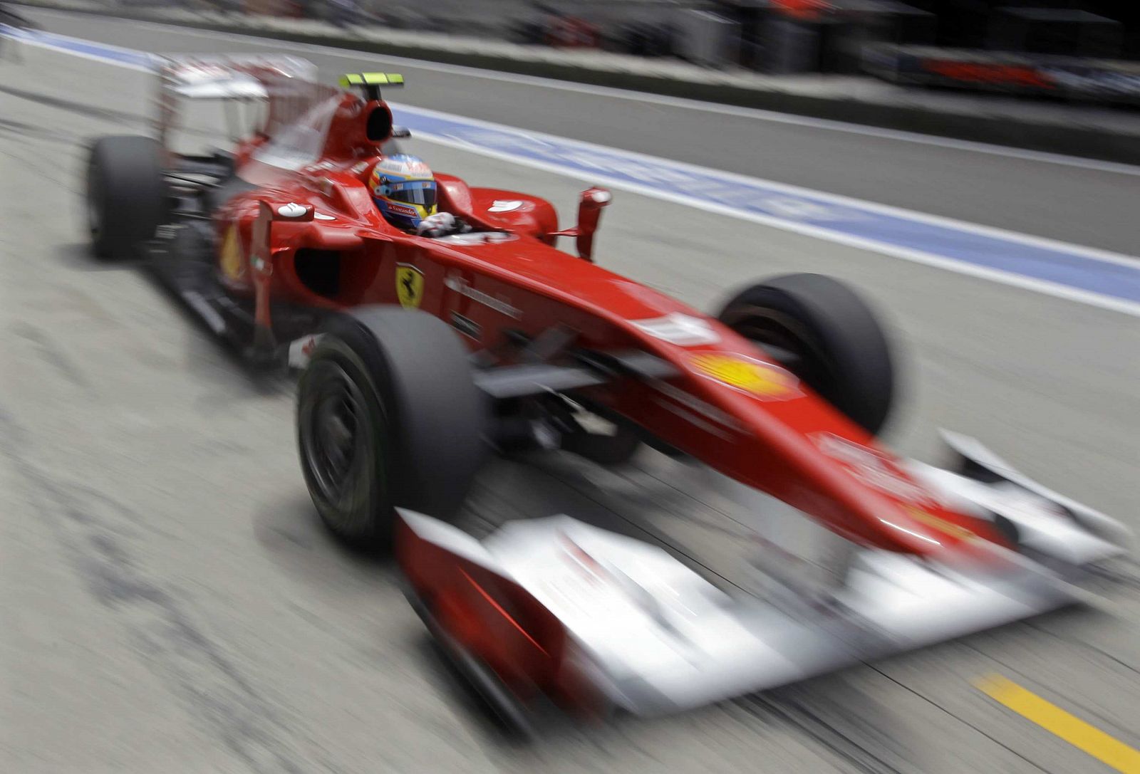 Ferrari Formula One driver Alonso arrives at the pit stop during the third practice session of the Chinese F1 Grand Prix at Shanghai International Circuit