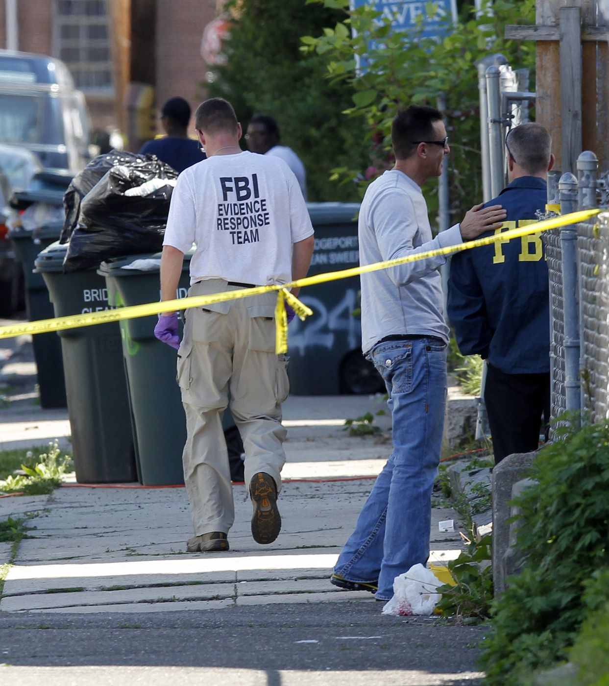 FBI investigators gather evidence and block sidewalk in front of the former home of Pakistani-American Faisal Shahzad in Connecticut