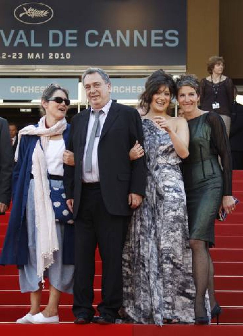 Director Stephen Frears poses with an unidentified women and cast member Tamsin Greig on the red carpet as they arrive at the 63rd Cannes Film Festival