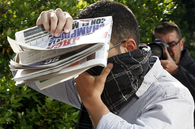 Uno de los 18 presuntos neonazis del grupo "Blood and Honour España" se tapa la cara a su llegada a la sede judicial.