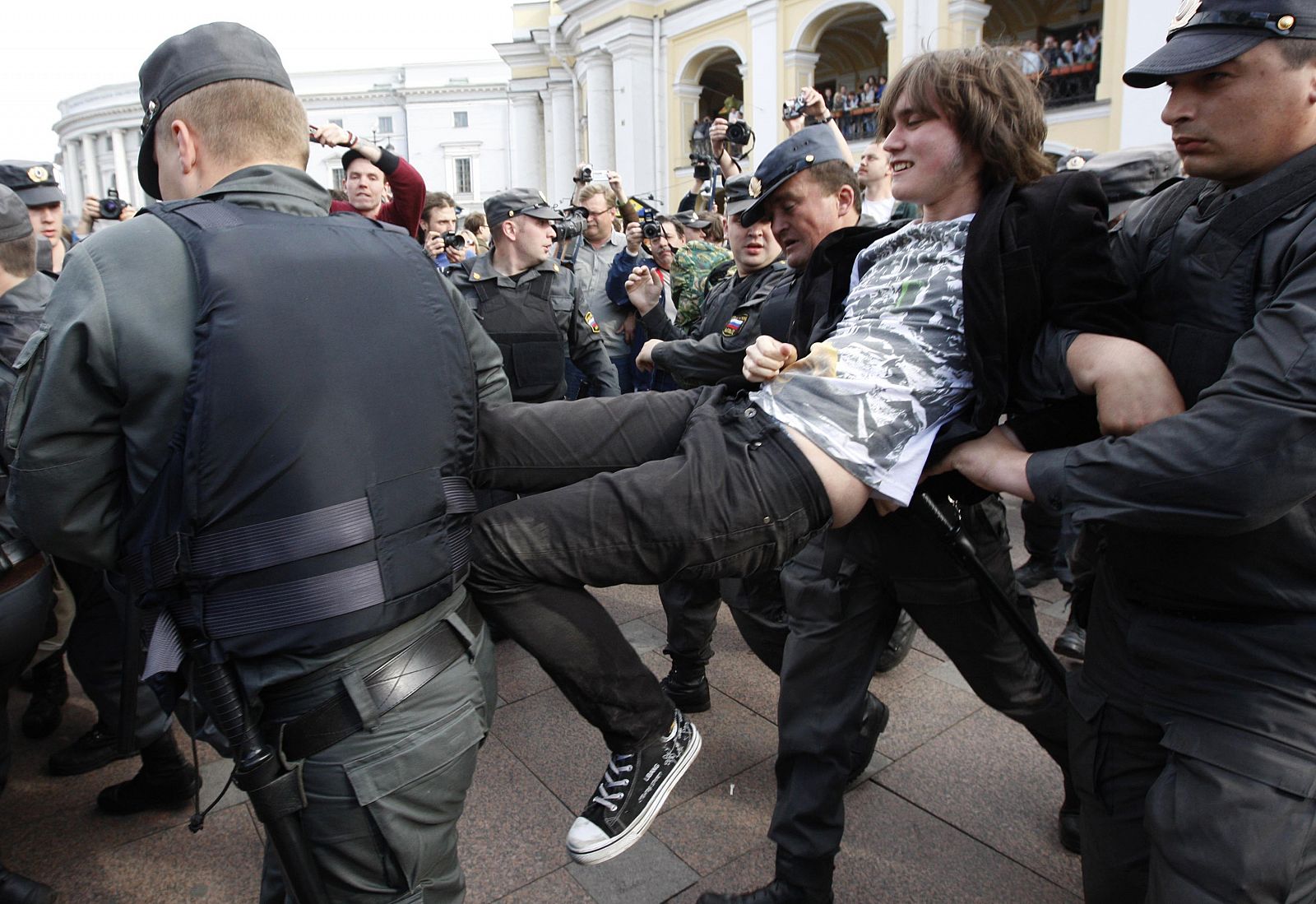 Russian policemen detain an opposition party supporter during a protest rally in central St. Petersburg