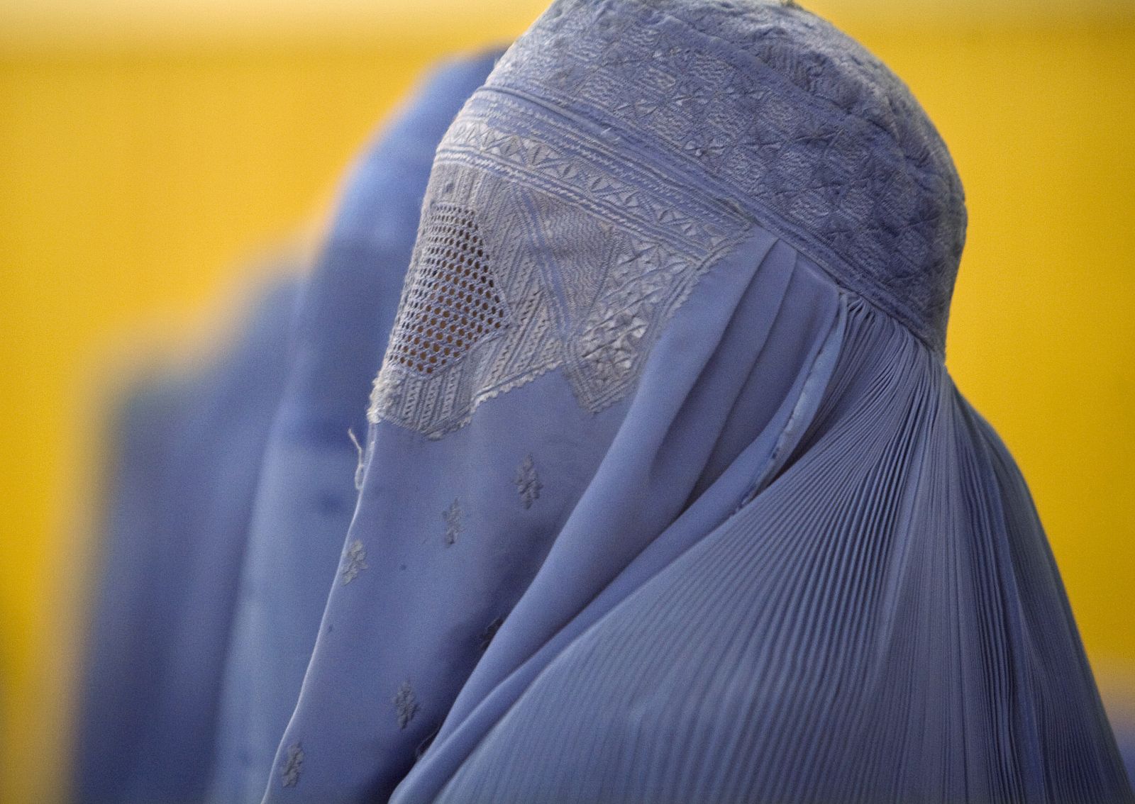 Afghan women attend a conference on violence against women in Herat