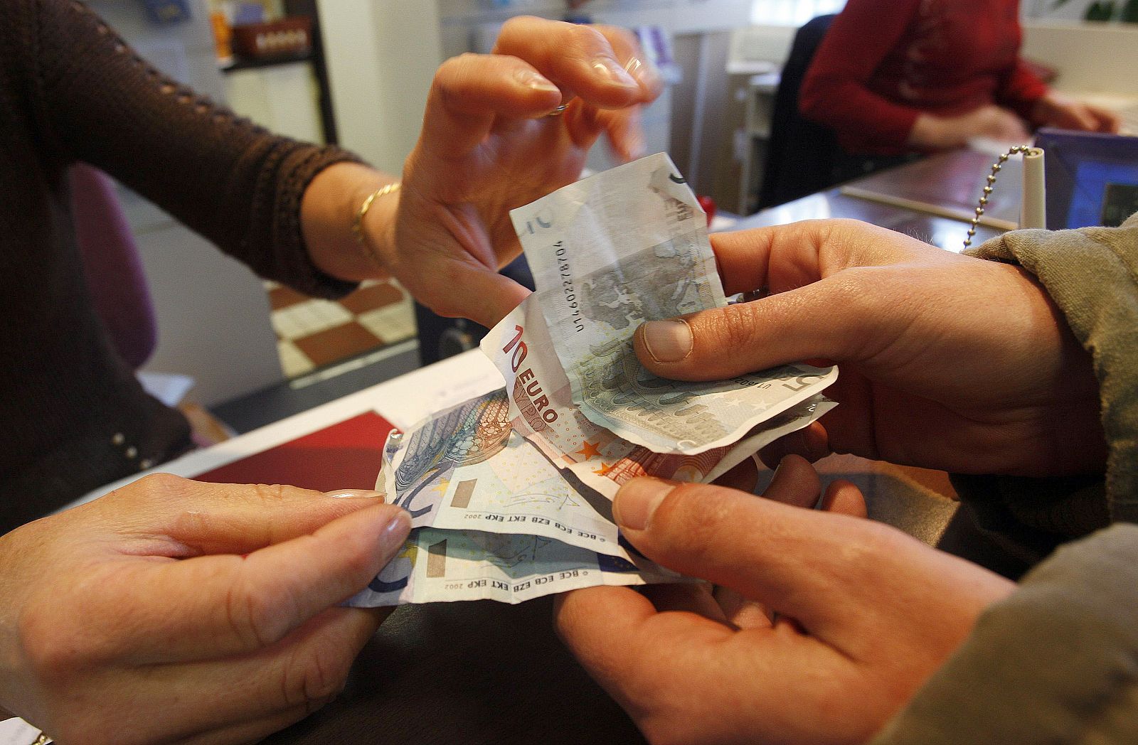 Man deposites money with La Banque Postale in Margaux