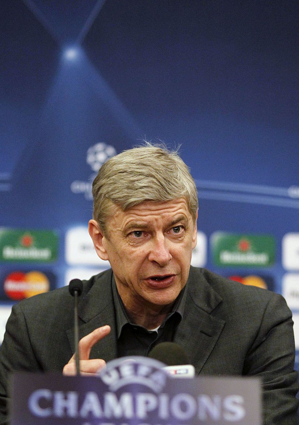Arsenal's coach Wenger answers a question during a news conference in Porto
