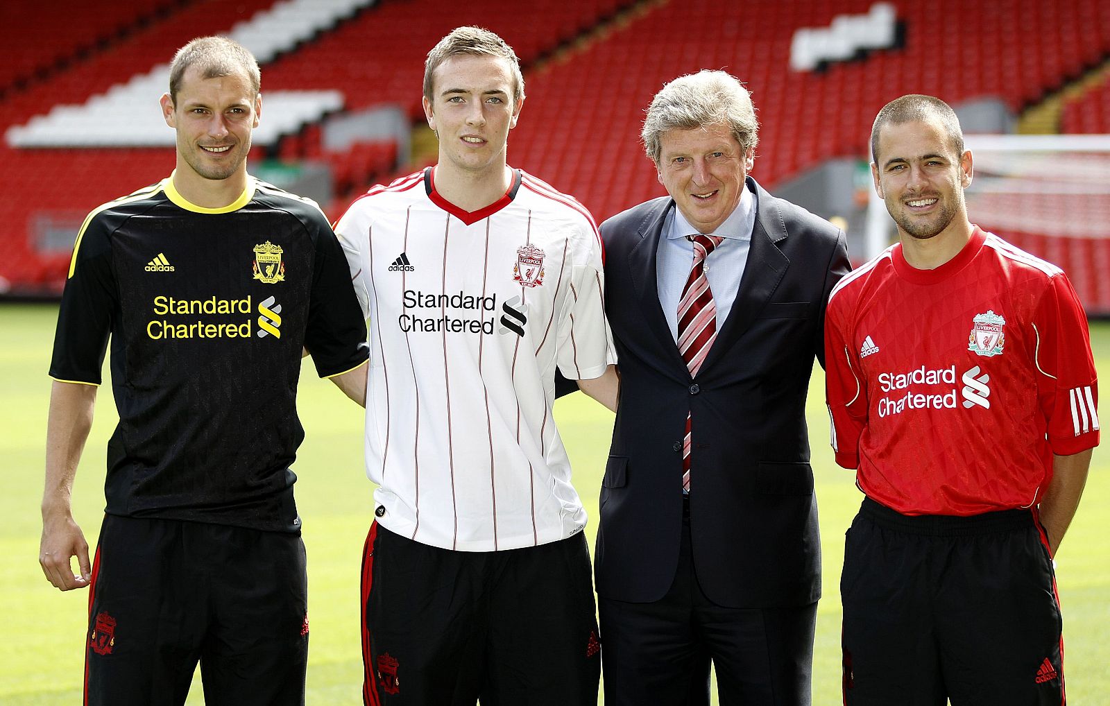 Liverpool manager Roy Hodgson poses for photographers with new signings Joe Cole, Danny Wilson and Milan Jovanovic following a news conference at the club's Anfield stadium in Liverpool