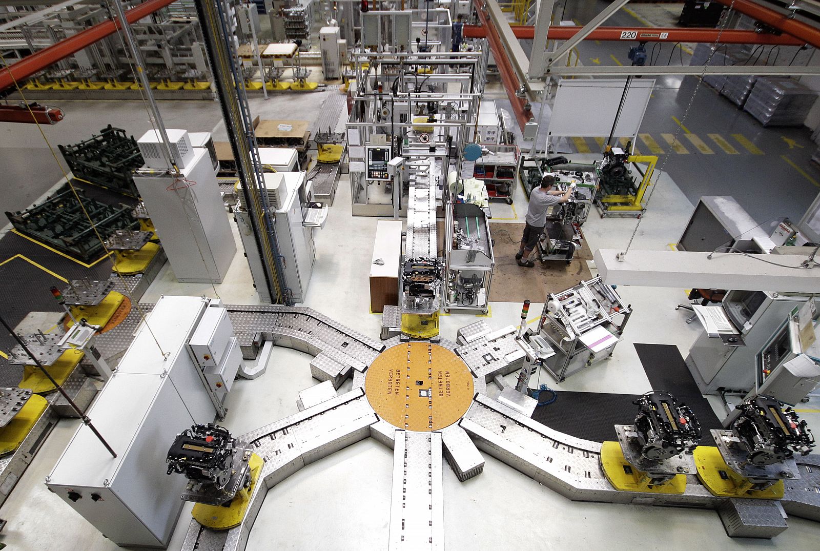 An employee of General Motors' Powertrain Austria GesmbH works on an engine in their plant in Vienna