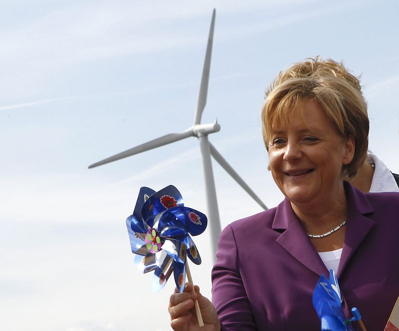 German Chancellor Merkel holds a windmill as she visits a wind turbine park 'WIND-projekt' in the northern German village of Ravensberg