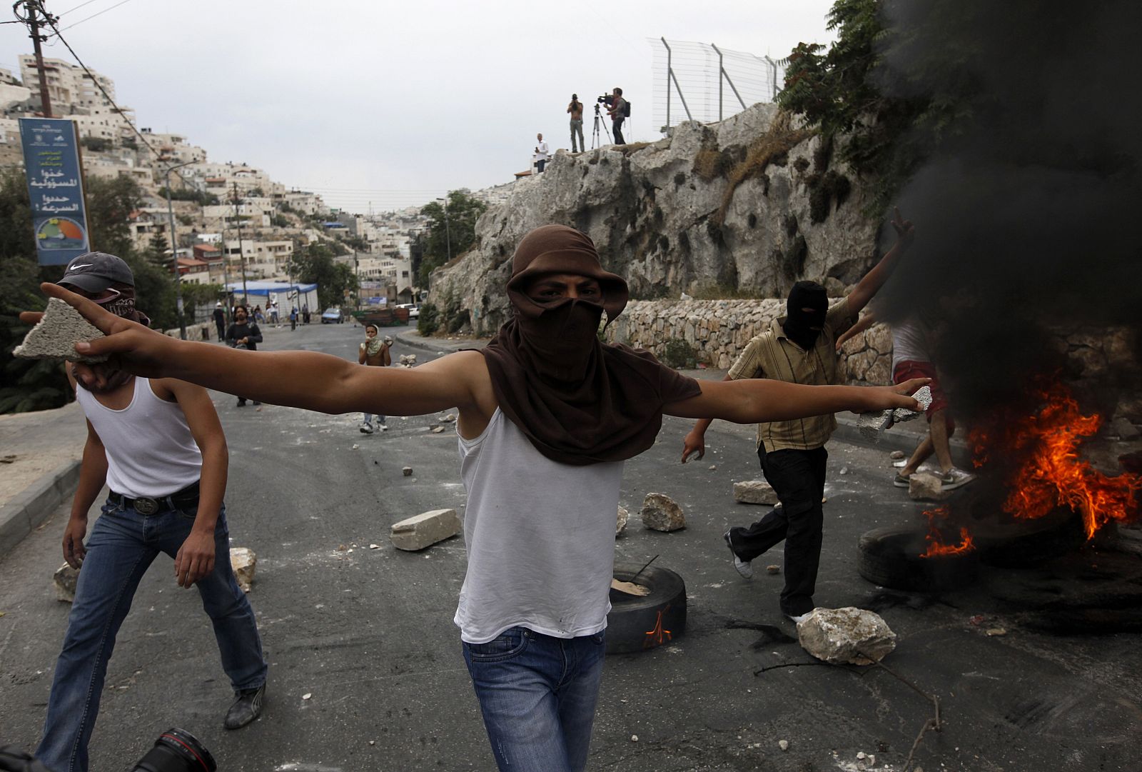 Palestinos queman neumáticos y tiran piedras a la Policía israelí.