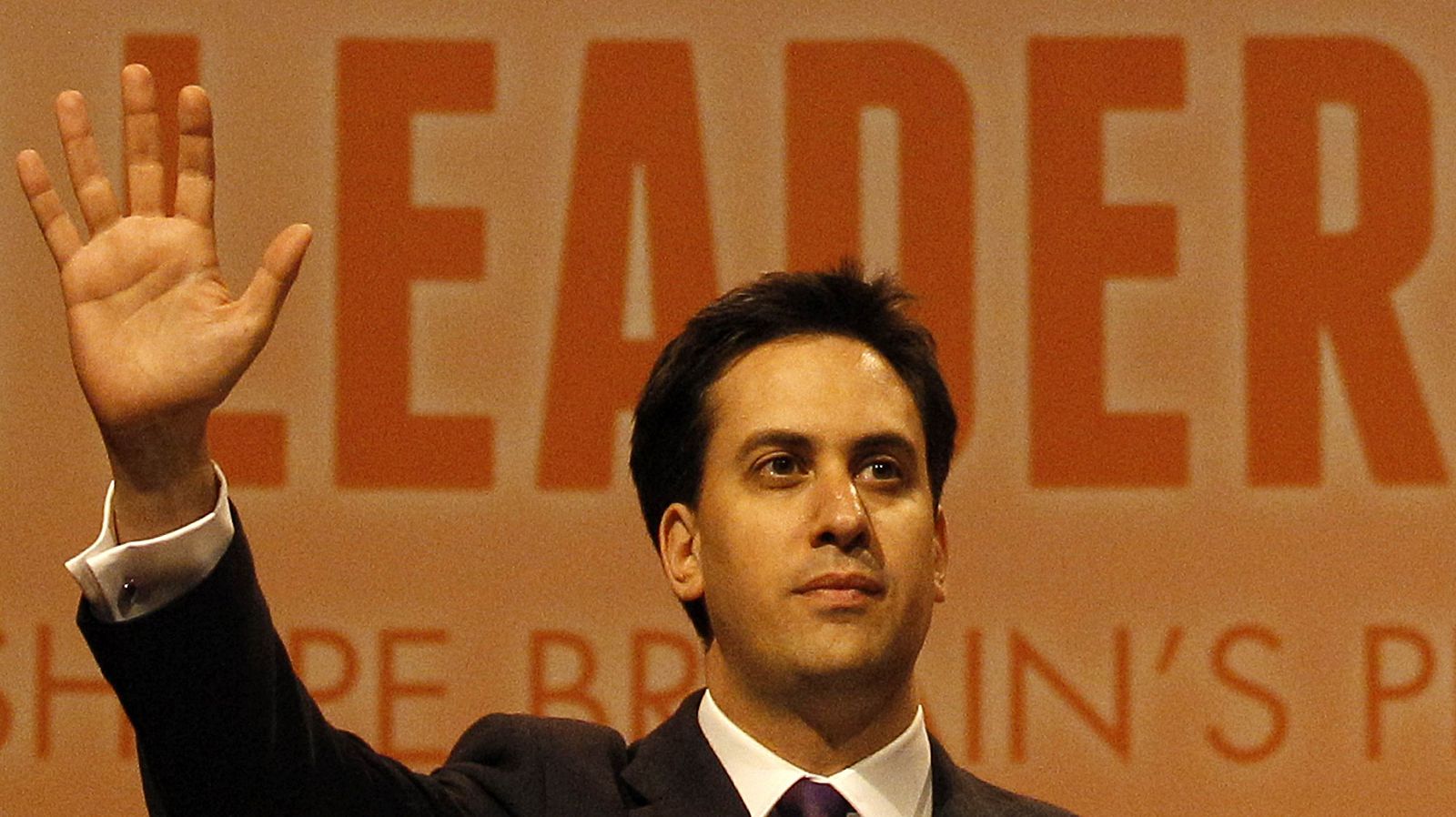 Former cabinet member Ed Miliband waves after being named the new leader of Britain's Labour Party at their annual conference in Manchester