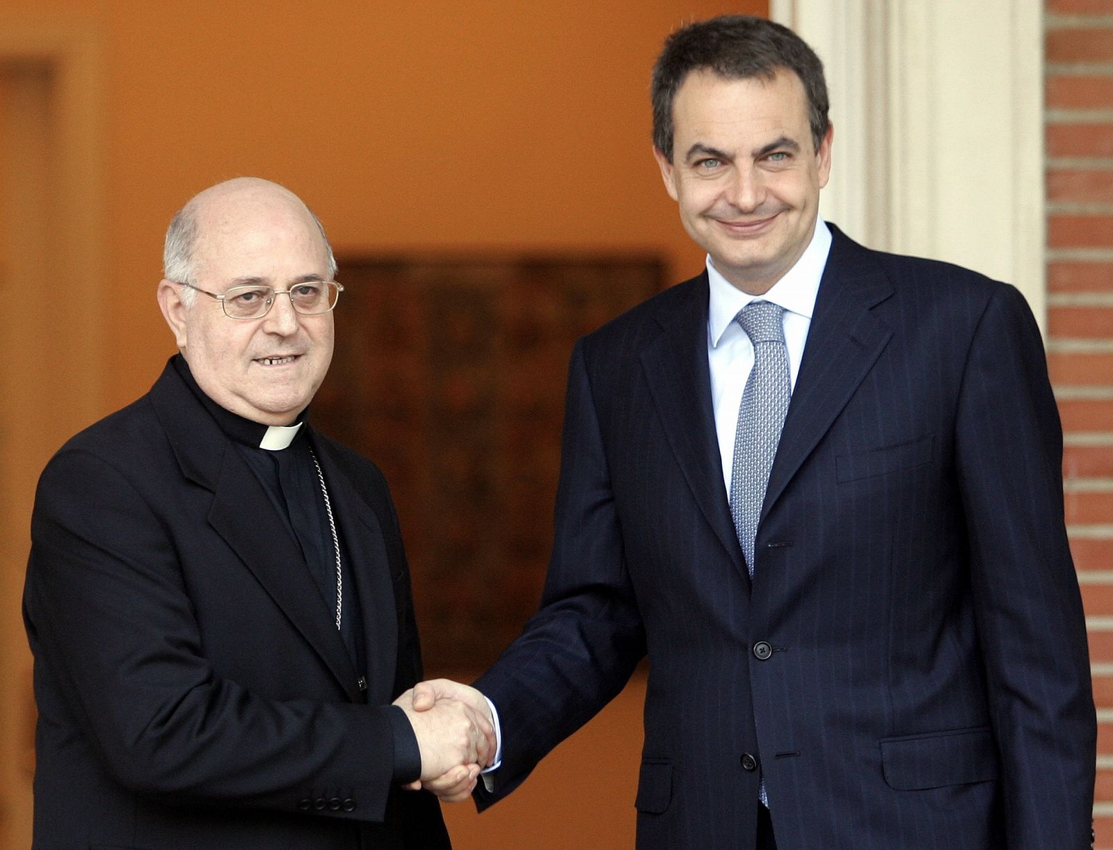 Bishop Blazquez is greeted by Spain's PM Zapatero before their meeting in Madrid.