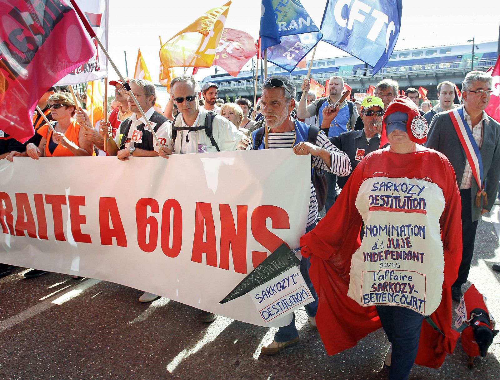 Private and public sector workers attend a demonstration over pension reforms in Lyon