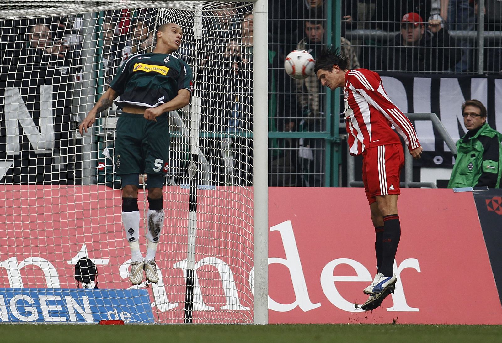 El jugador del Bayern de Munich, Mario Gomez, dispara de cabeza ante el portero del Borussia en un partido de la Bundesliga.