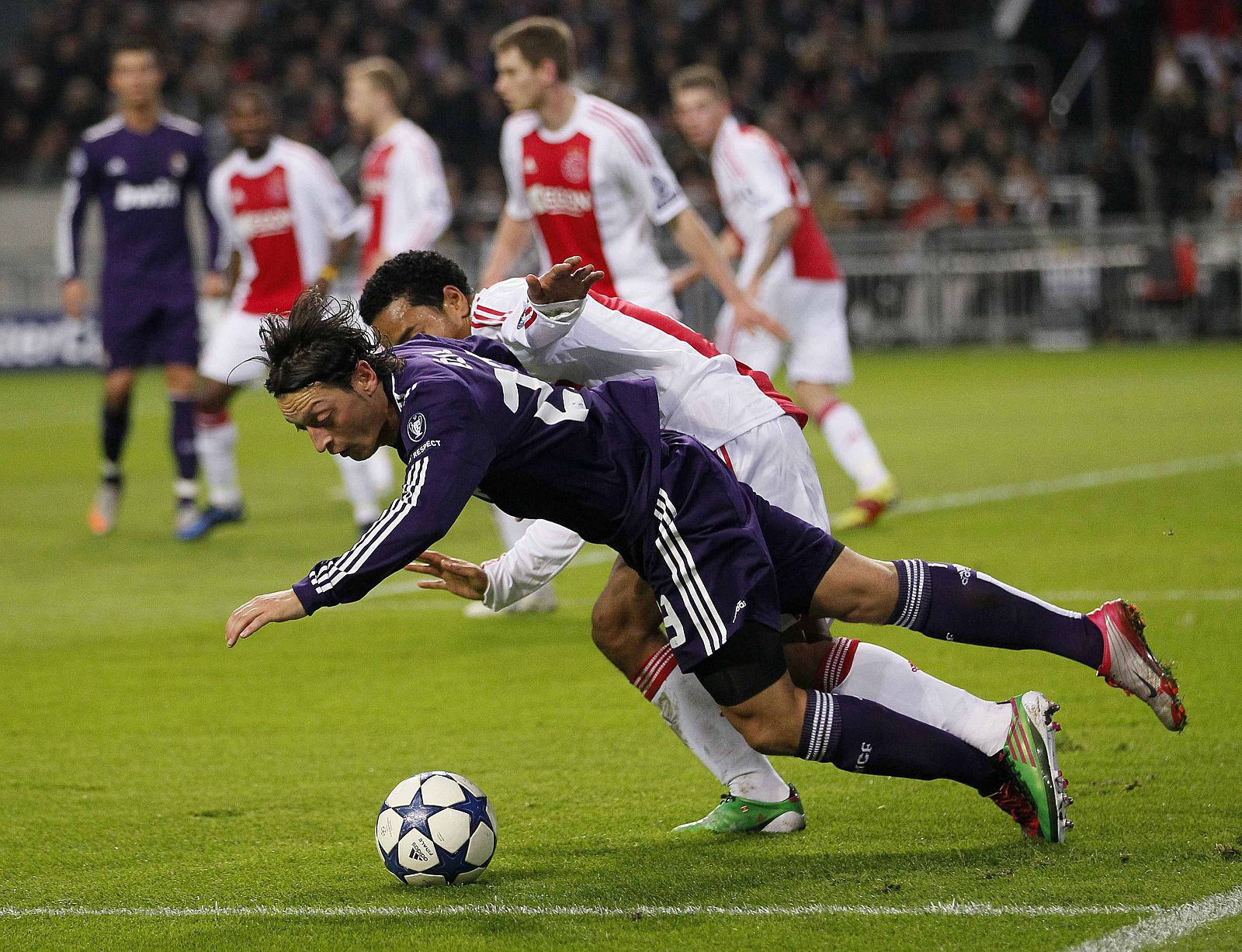Real Madrid's Ozil is fouled by Ajax Amsterdam's Emanuelson during their Champions League Group G soccer match in Amsterdam