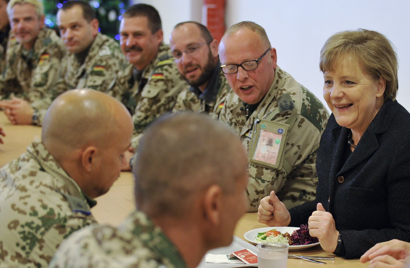 German Chancellor Merkel chats with soldiers during a lunch as she visits an army camp in Kunduz