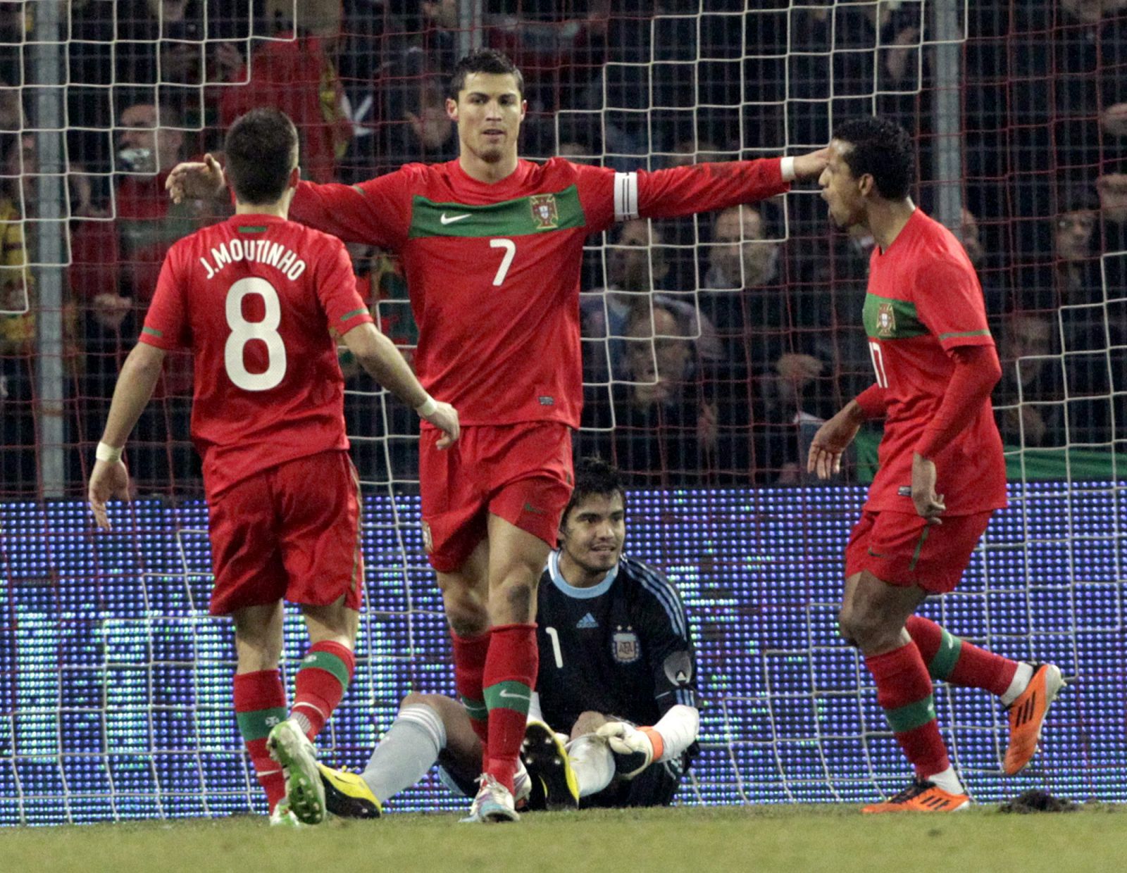 Portugal's Ronaldo scores a goal against Argentina's goalkeeper Romero during their international friendly soccer match at the Stade de Geneve in Geneva