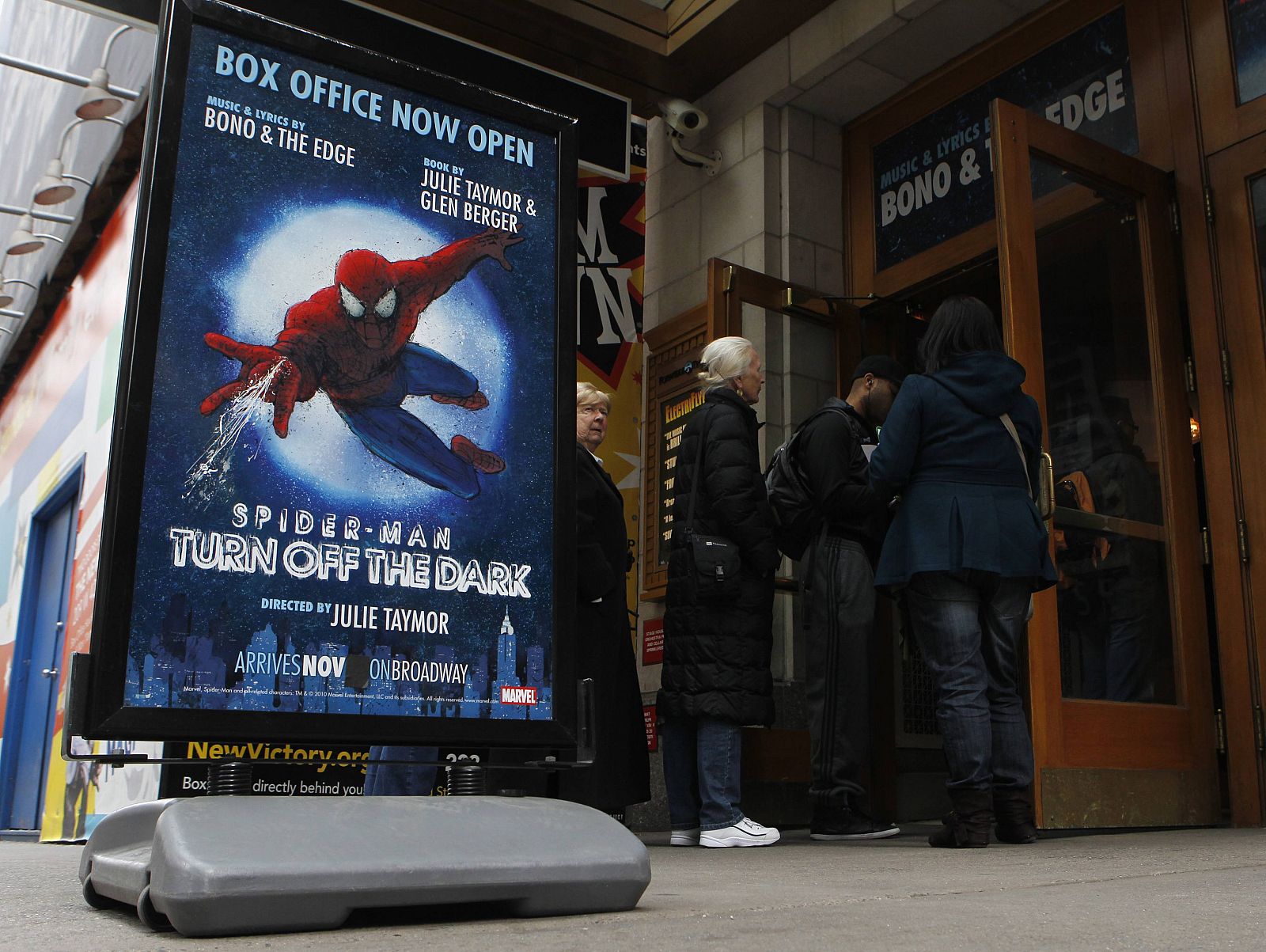 Patrons wait in line at the box office of the Foxwoods Theater, home to the Broadway play ''Spiderman: Turn Off The Dark'' in New York