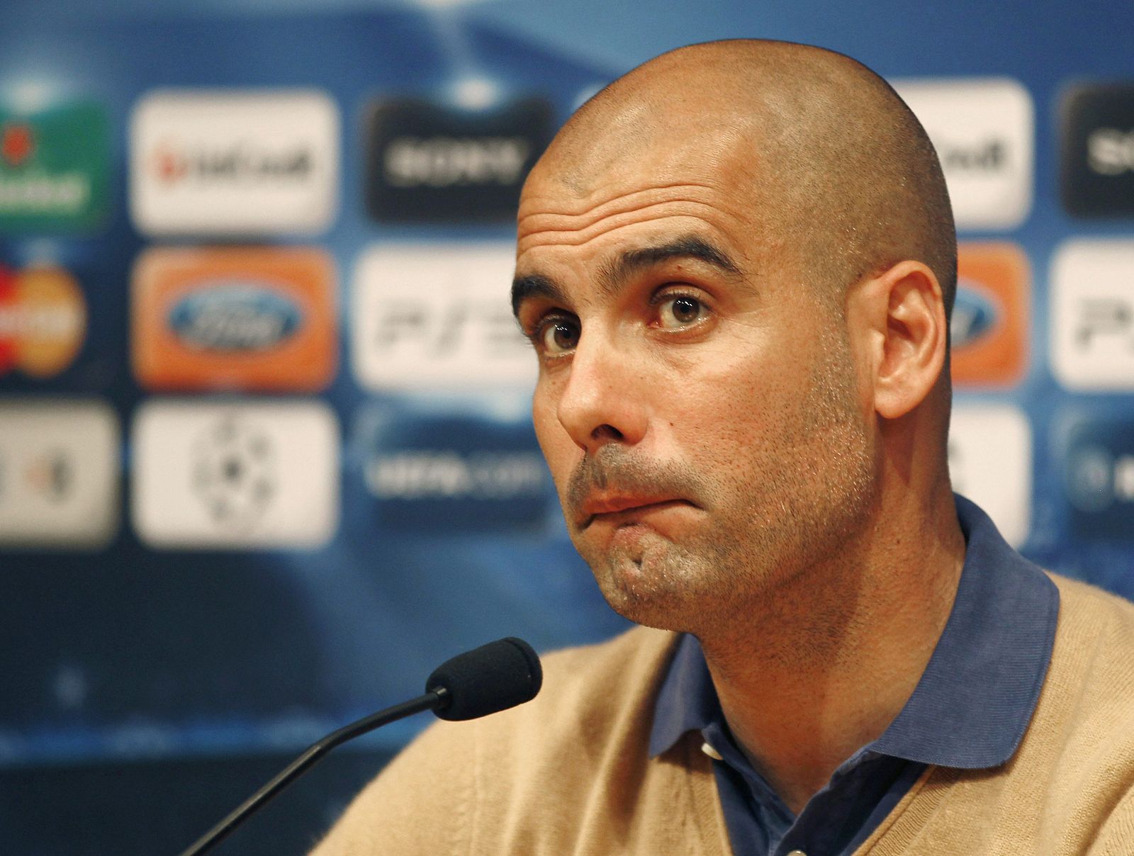 Barcelona's coach Pep Guardiola answers a question during a news conference at Nou Camp stadium in Barcelona