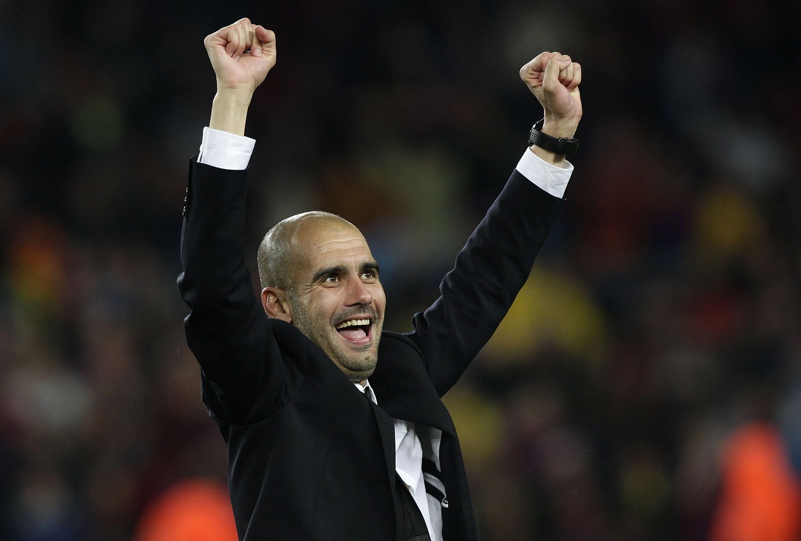 Barcelona's coach Guardiola celebrates after qualifying for the final at the end of their Champions League semi-final second leg soccer match against Real Madrid in Barcelona