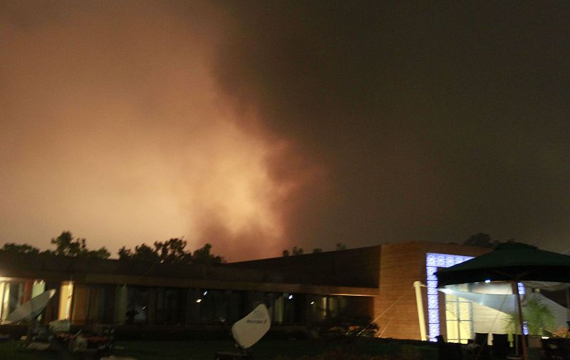 Smoke rises above buildings in Tripoli
