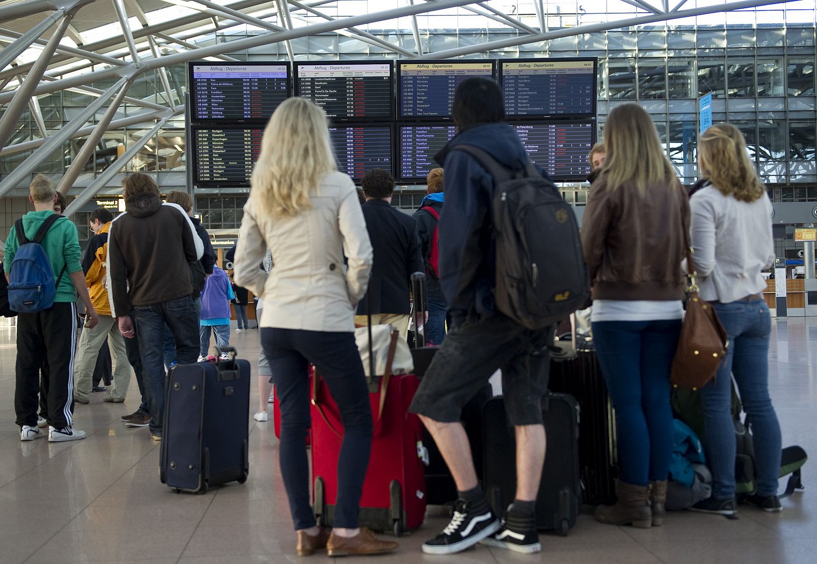 Pasajeros del aeropuerto de Hamburgo comprueban si sus vuelos están cancelados.