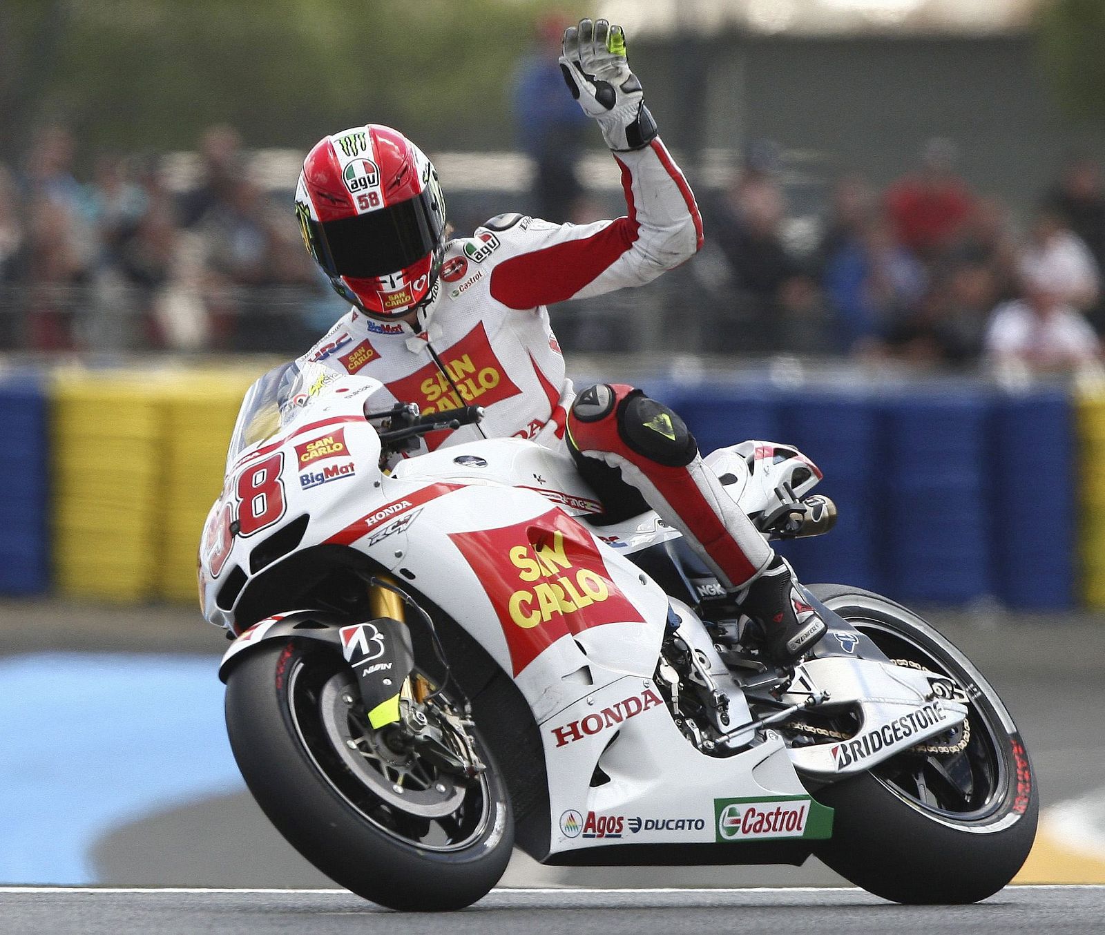 Honda MotoGP rider Marco Simoncelli of Italy celebrates after qualifying practice at the French Grand Prix at the Le Mans circuit in central France