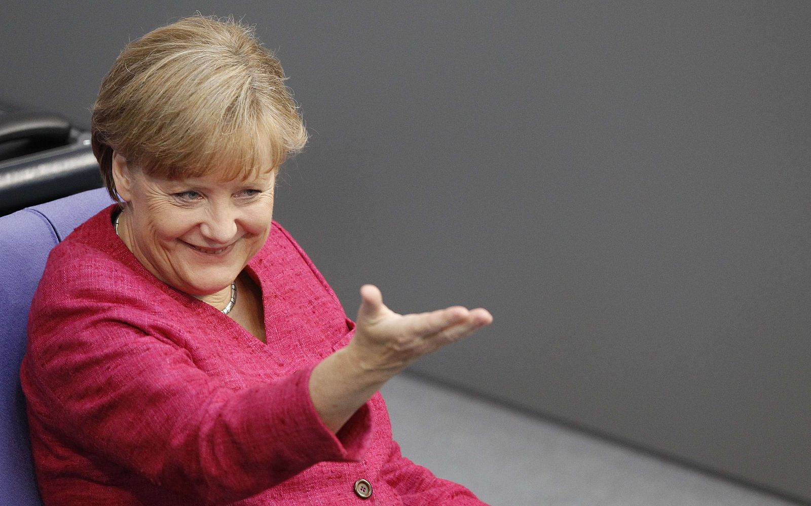 German Chancellor Merkel reacts during Bundestag session in Berlin