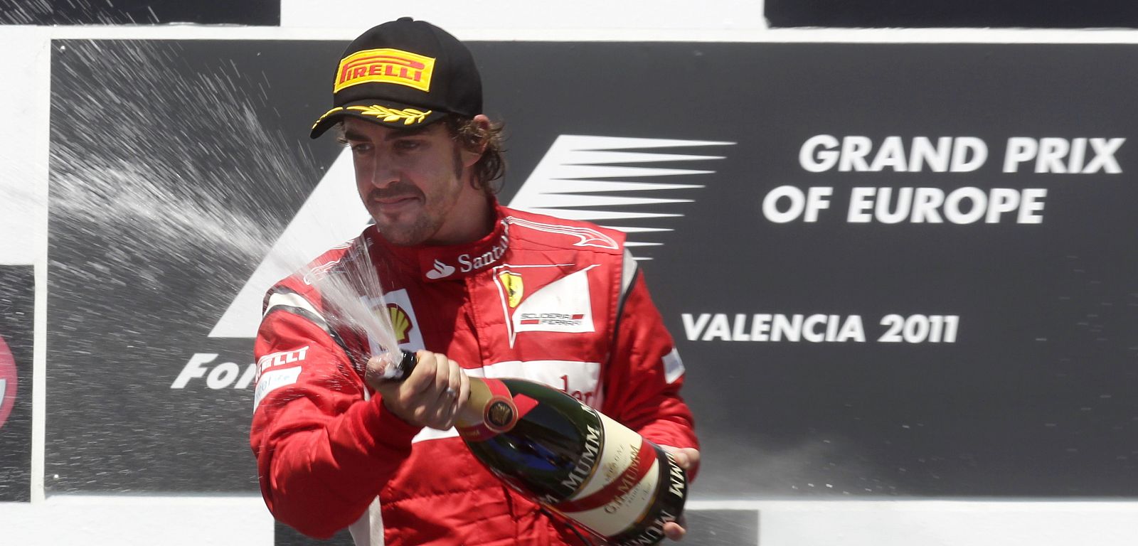 Ferrari's Alonso of Spain sprays champagne on the podium after taking the second place at the European F1 Grand Prix in Valencia