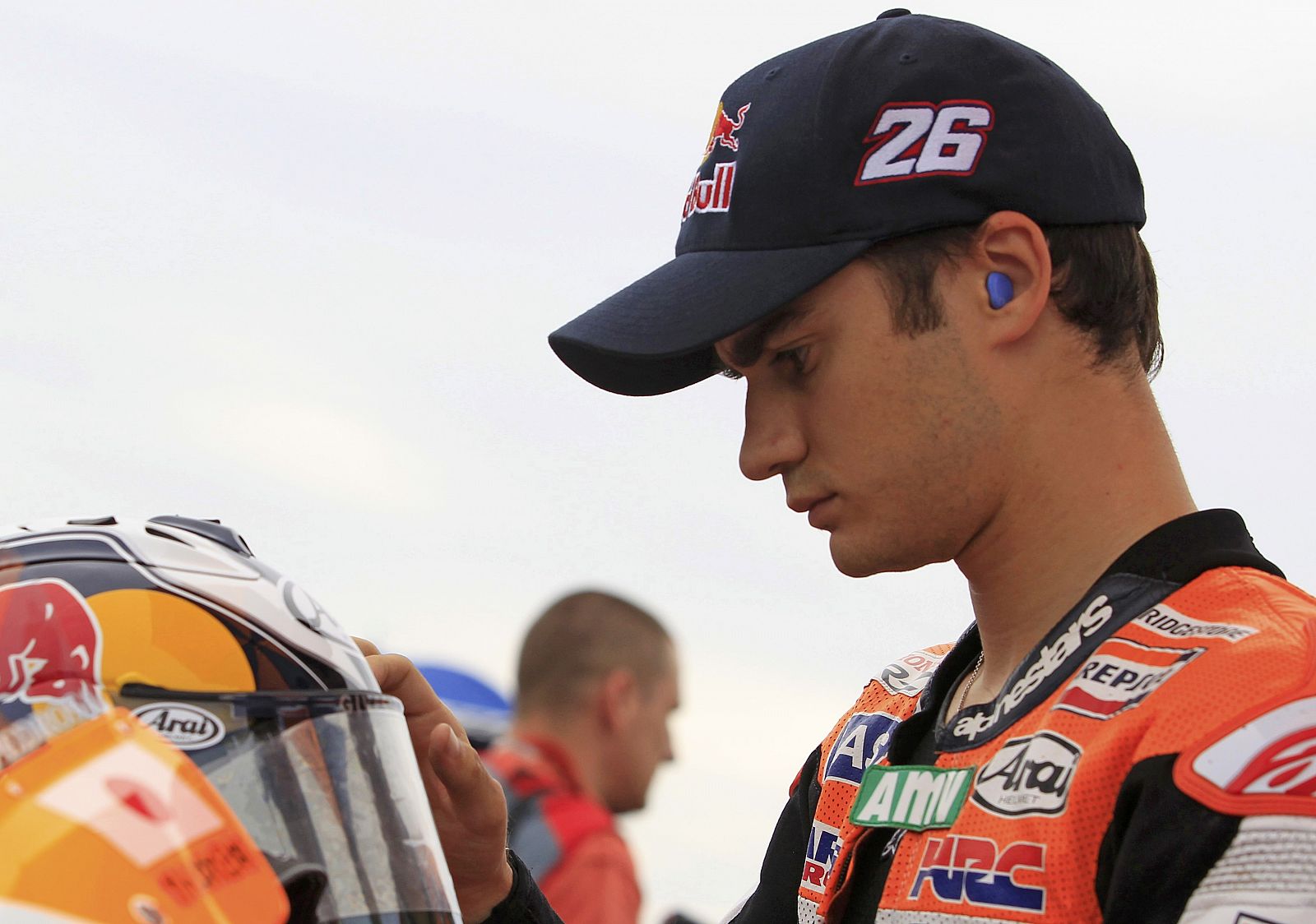 Honda MotoGP rider Pedrosa of Spain checks his helmet before the start of the German motorcycling Grand Prix at the Sachsenring circuit in Hohenstein-Ernstthal