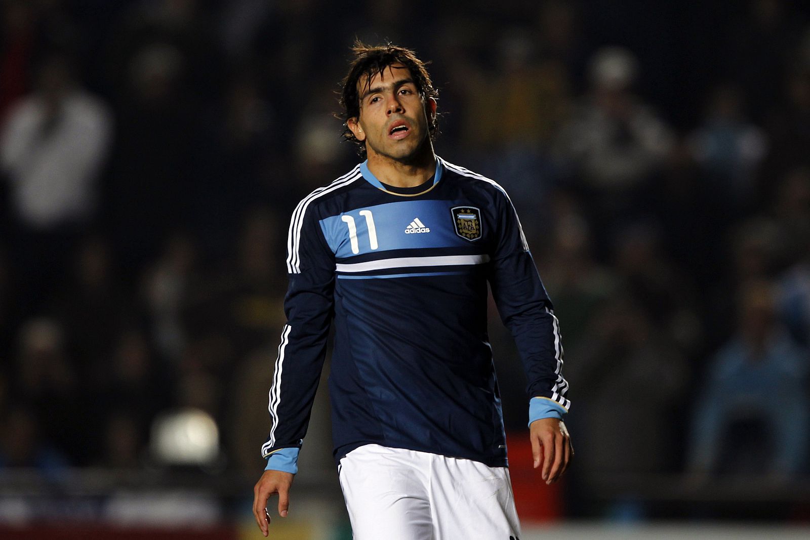 Argentina's Carlos Tevez walks away after his penalty kick was blocked by Uruguay's goalkeeper Fernando Muslera during their quarter-final soccer match at the Copa America in Santa Fe