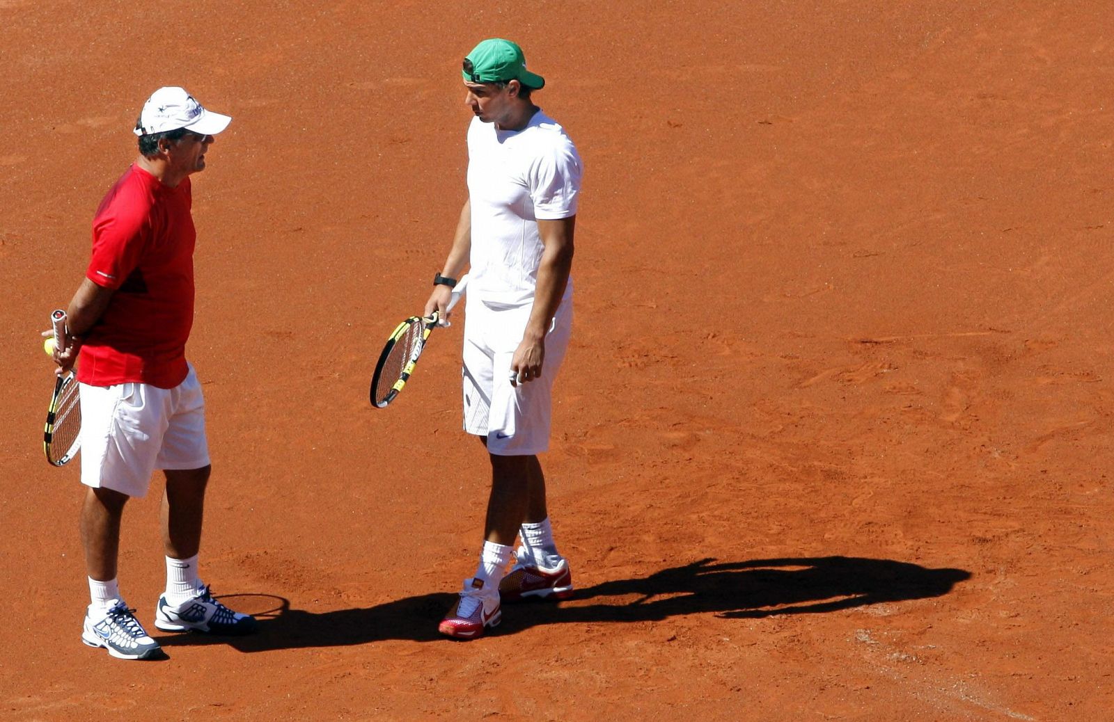 Rafa Nadal conversa con su tío Toni durante el entrenamiento