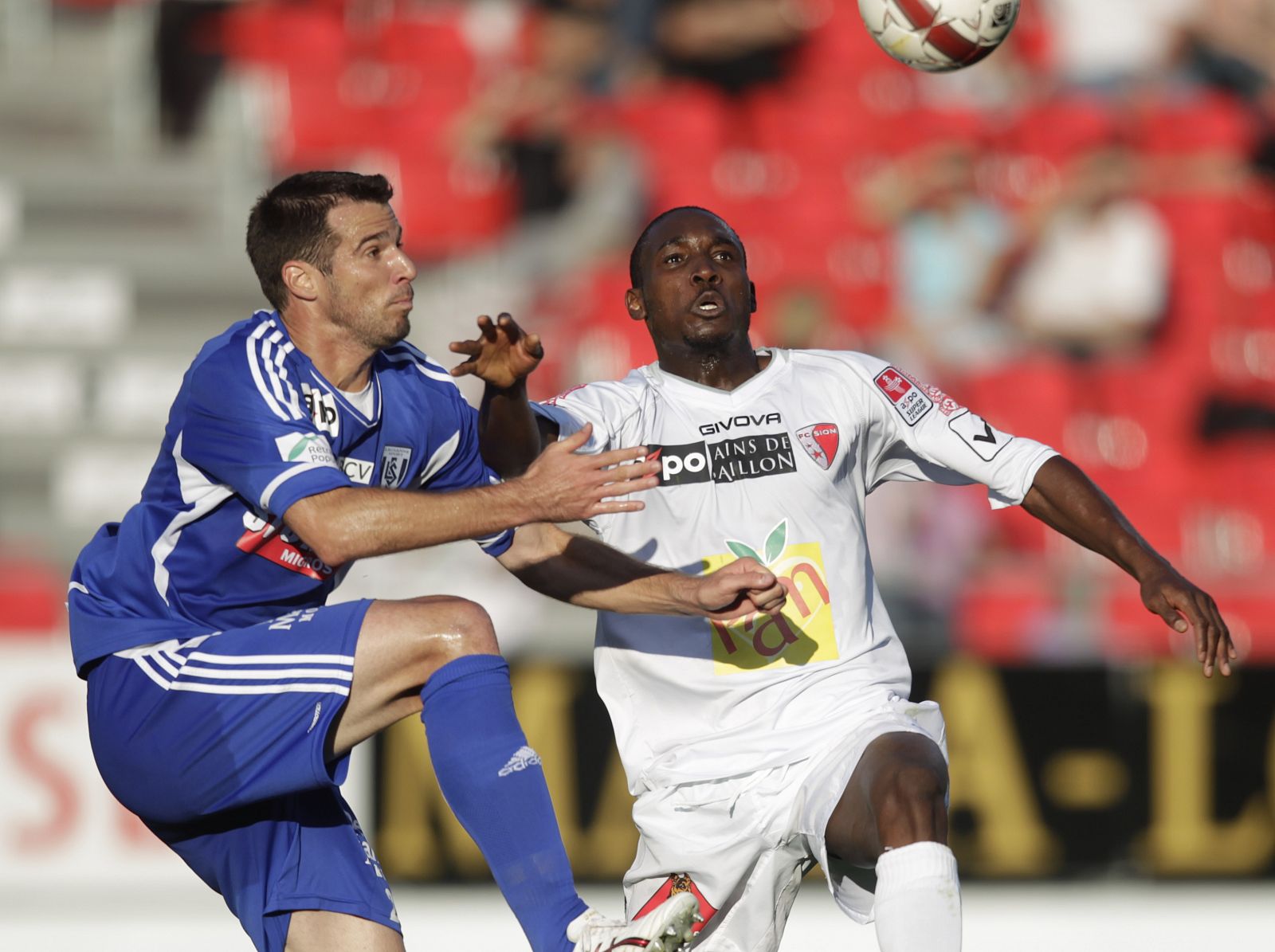 FC Lausanne-Sport's Page eyes the ball next to FC Sion's Sio during their Swiss Super League soccer match in Sion