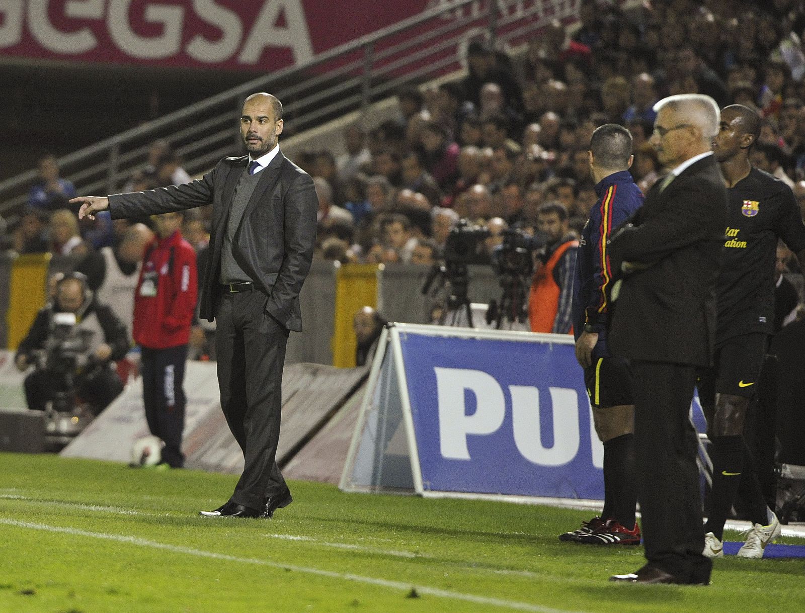 El entrenador del Granada, Fabriciano González, 'Fabri', con Guardiola de fondo, en el encuentro que enfrentó a sus equipos.