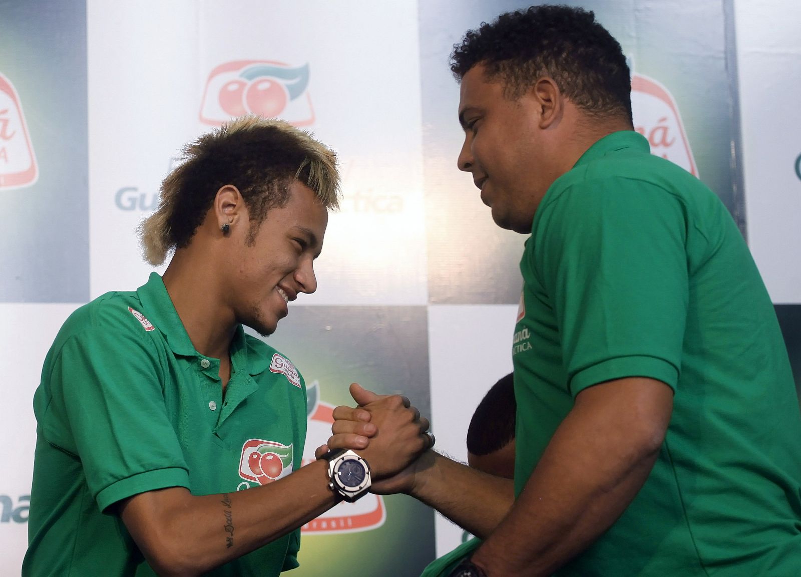 Former Brazilian striker Ronaldo shakes hands with Neymar of Brazil's Santos before a news conference in Sao Paulo